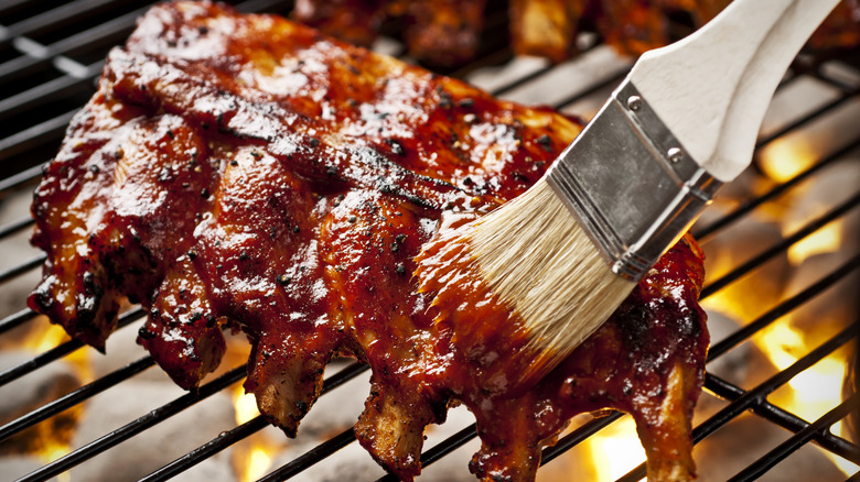 Glazing baby back ribs on the grill