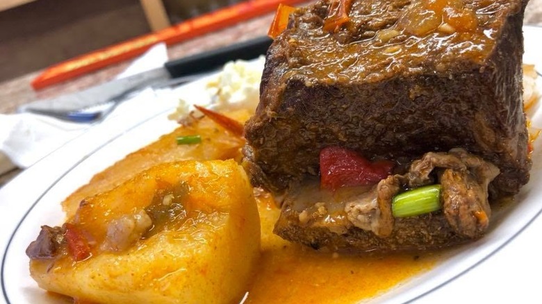 Beef ribs on a plate with sides
