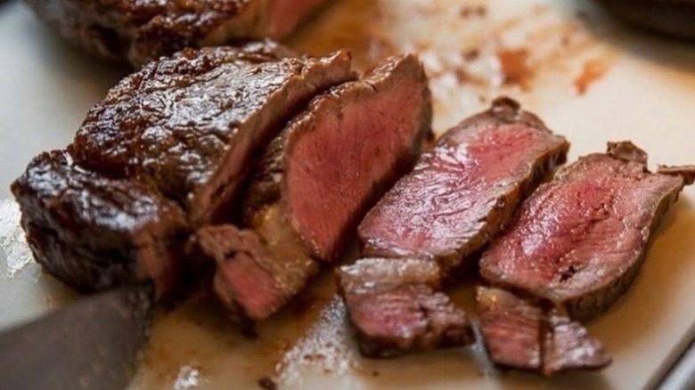 Steak being cut into slices