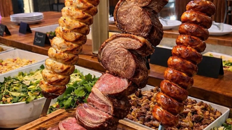 Three skewers of meat on a cold bar
