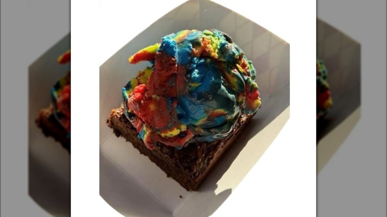 Brownie topped with large scoop of multi-colored ice cream