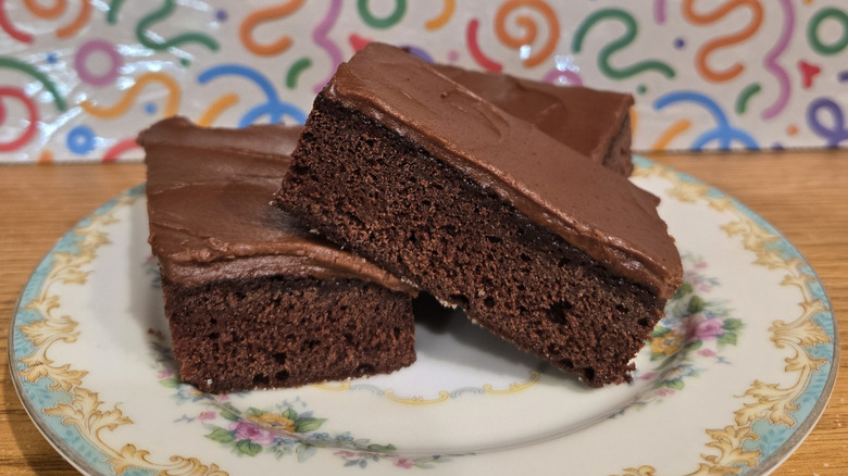 Three iced brownies on plate