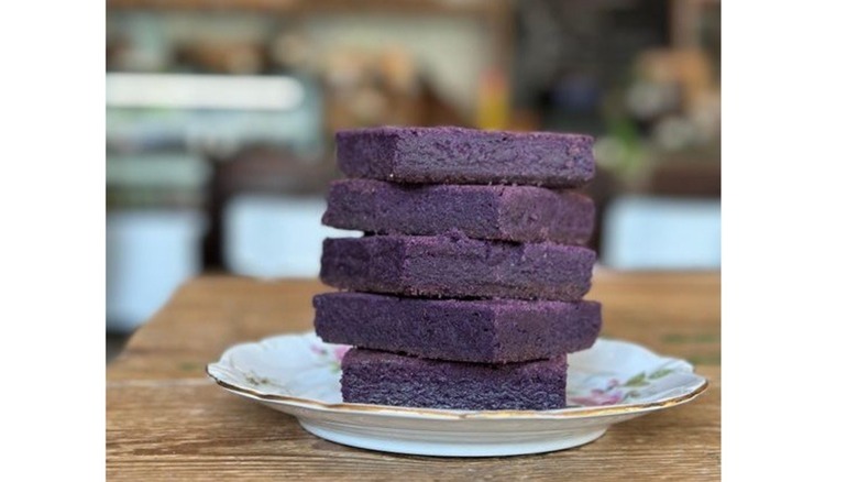 Five ube brownies stacked on plate