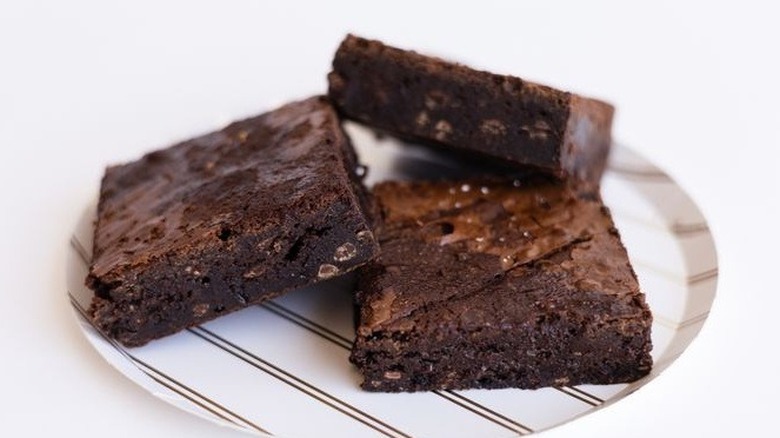 Three dense brownies on plate