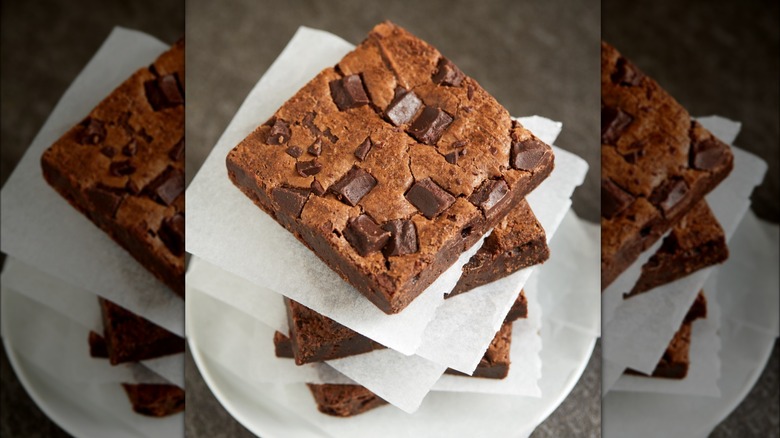 Stack of several brownies filled with chocolate chunks