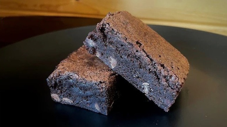 Two triple chocolate fudge brownies stacked atop one another