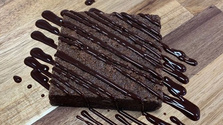 Single brownie drizzled with chocolate