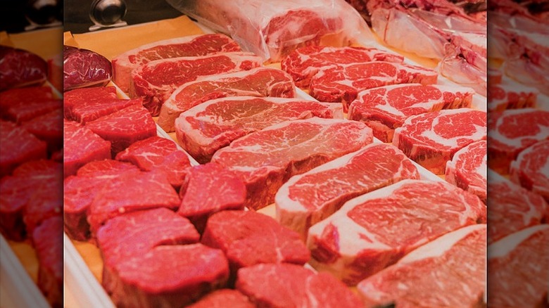 Butcher shop display case with fresh cuts of meat.