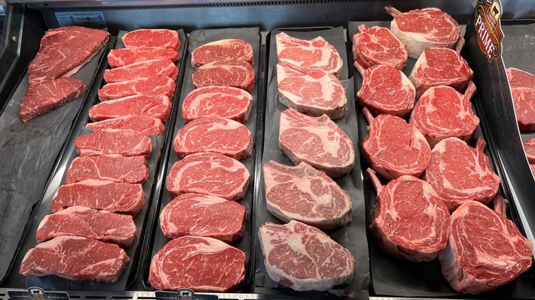 Butcher shop display case with fresh cuts of meat.