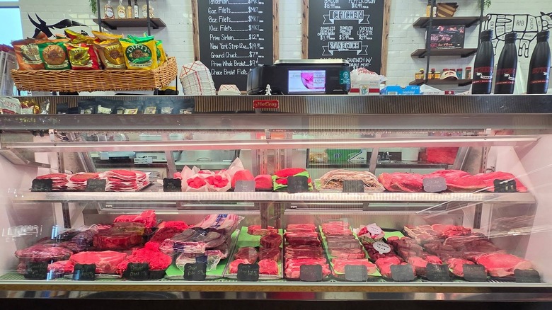 Butcher shop display case with fresh cuts of meat.