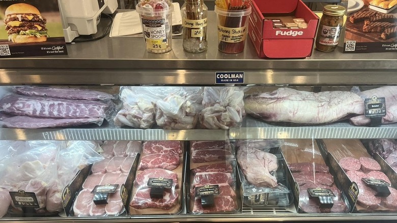 Butcher shop display case with fresh cuts of meat.