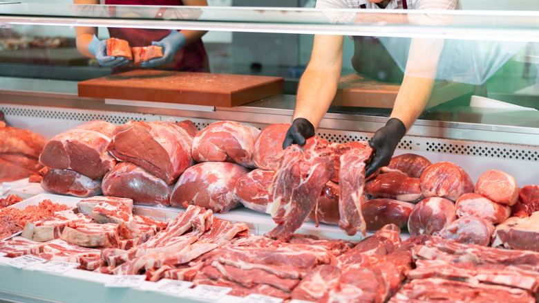 Butcher shop display case with fresh cuts of meat.