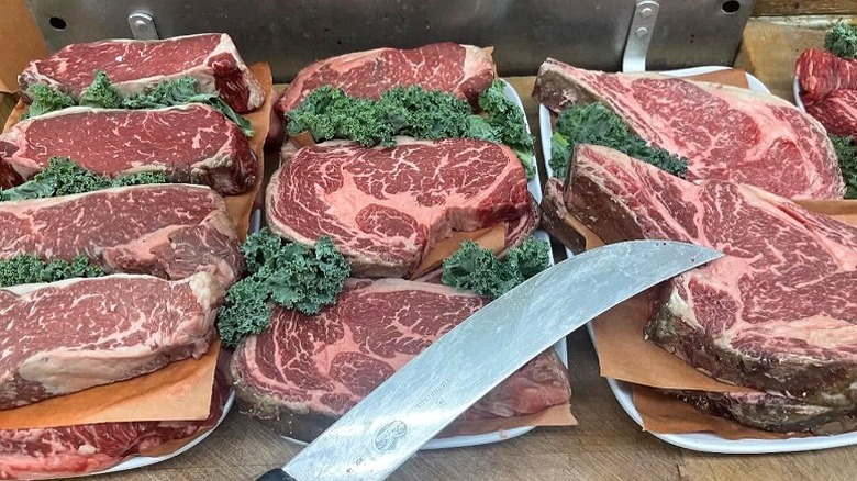 Rows of fresh cuts of ribeye and New York strip.