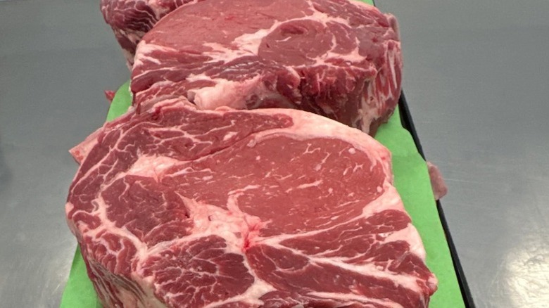 Two fresh cuts of well-marbled steak.