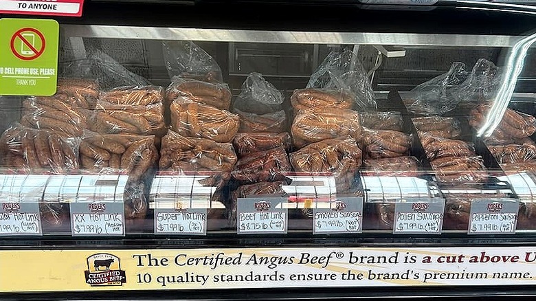 Butcher display case full of bagged sausage links.