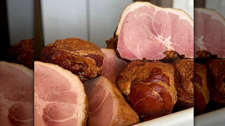 Pile of smoked ham halves.