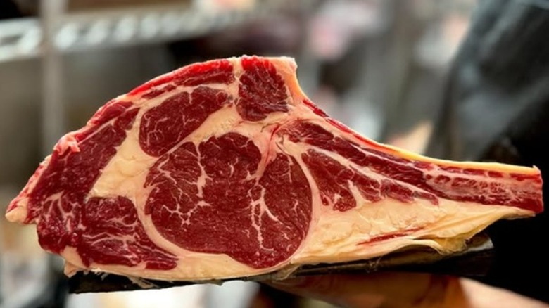 Well-marbled raw rib roast.