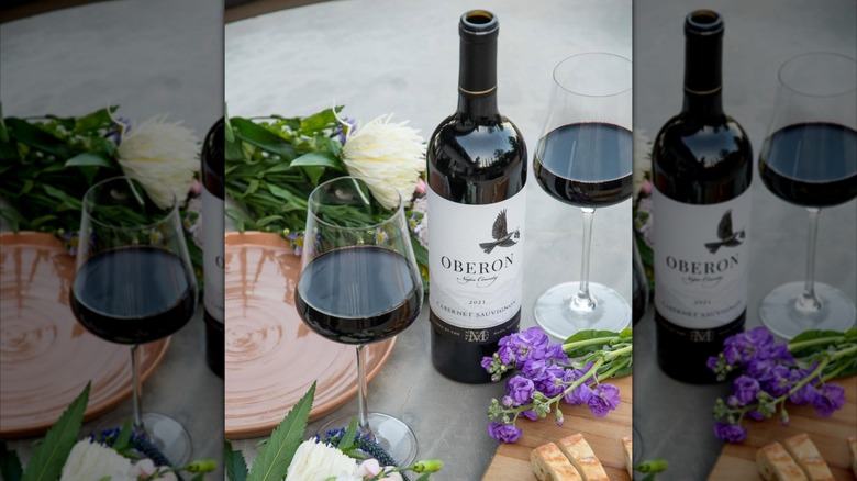 Bottle of Oberon Cabernet Sauvignon Napa County with flowers and a glass
