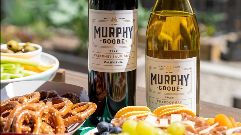 Bottle of Murphy Goode cabernet sauvignon and chardonnay on a table with food.