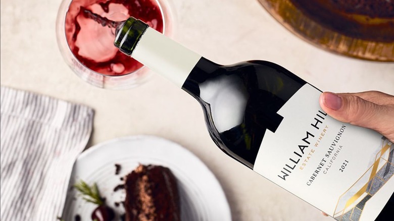 Pouring a bottle of William Hill cabernet sauvignon into a glass