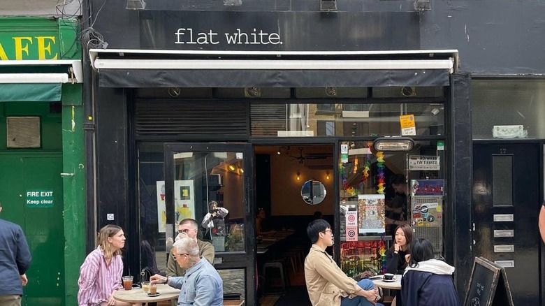 Image of the exterior of Flat White with patrons enjoying coffee on outdoor tables