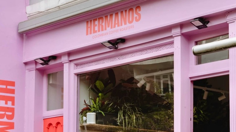 Pink and red storefront of Hermanos Colombian Coffee Roasters
