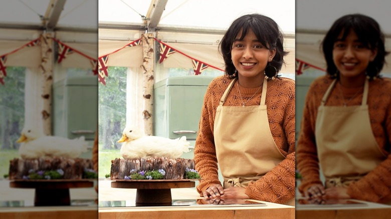 A duck shaped cake on tree stump with Great British Bake Off contestant Sumayah Kazi.