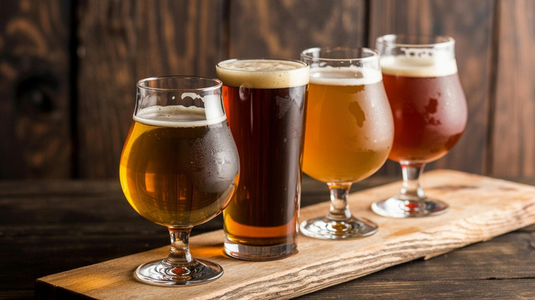 Four beers on a wooden board