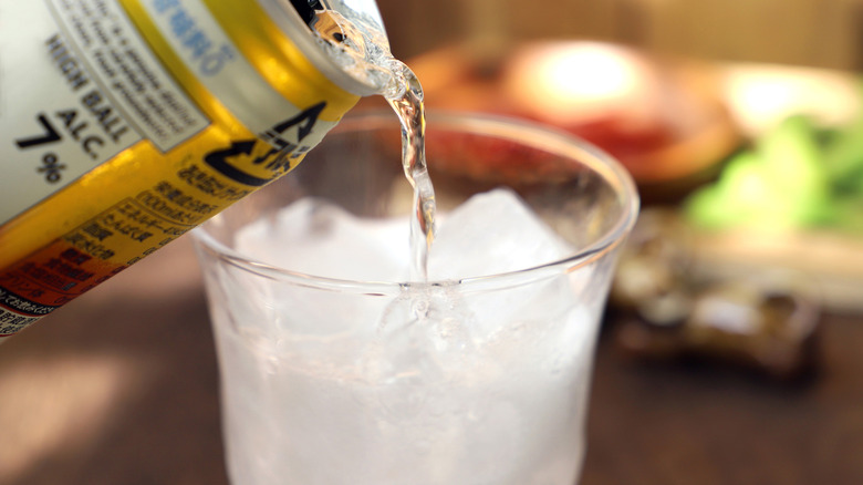 pouring canned cocktail into cup