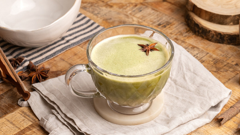Chai matcha latte in a glass mug, garnished with star anise