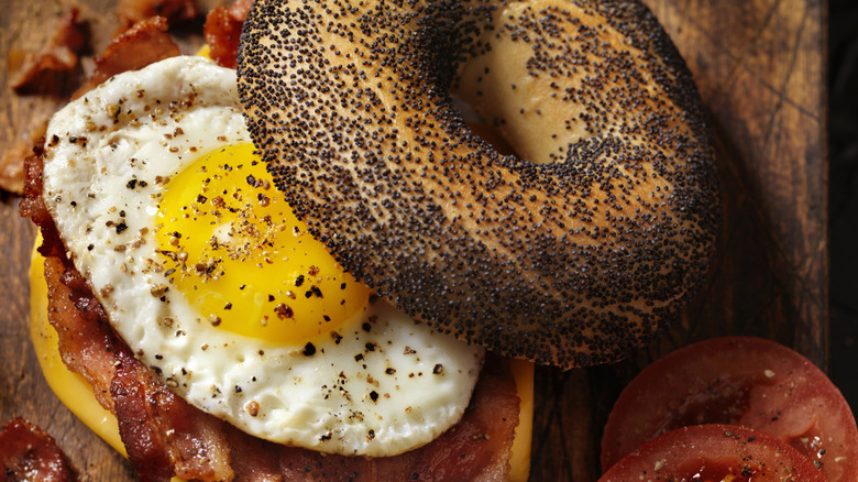 Poppyseed bagel breakfast sandwich with egg