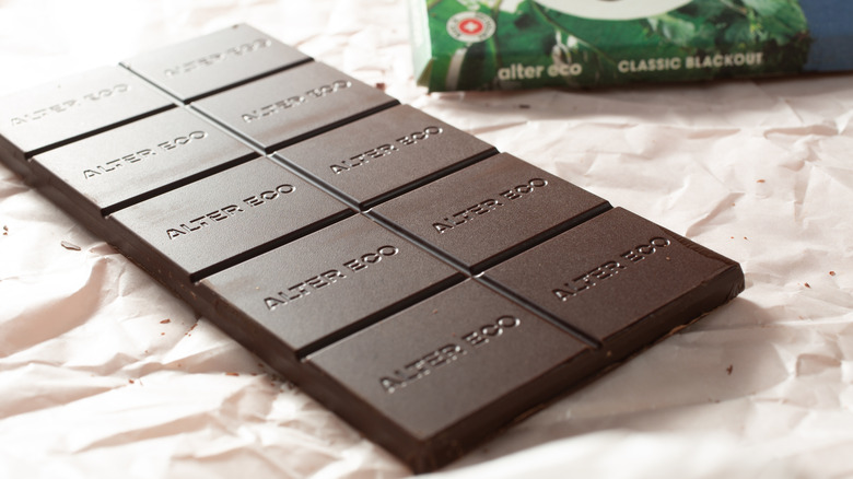 Alter Eco classic blackout chocolate bar on paper with its sleeve in the background