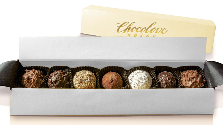 Box of seven truffles in various flavors with Chocolove packaging in the background