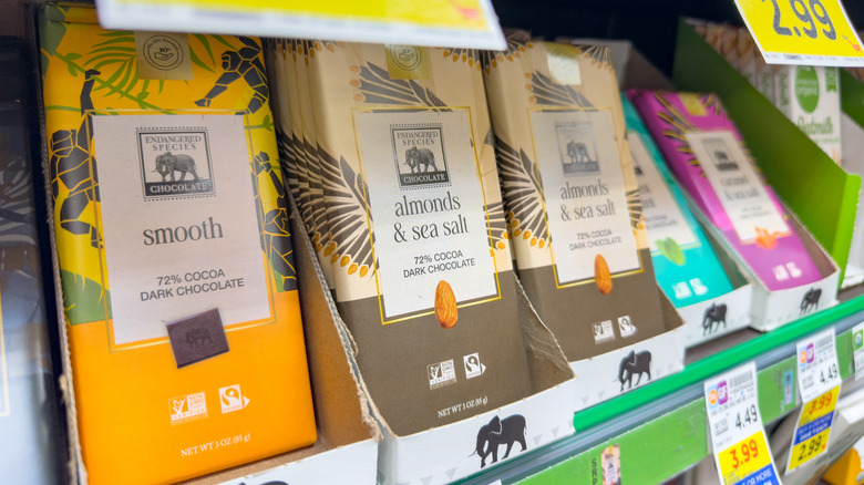 Several flavors of Endangered Species Chocolate bars on a grocery store shelf