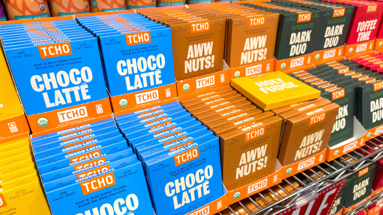 Packages of TCHO Chocolate in various flavors on grocery store shelves