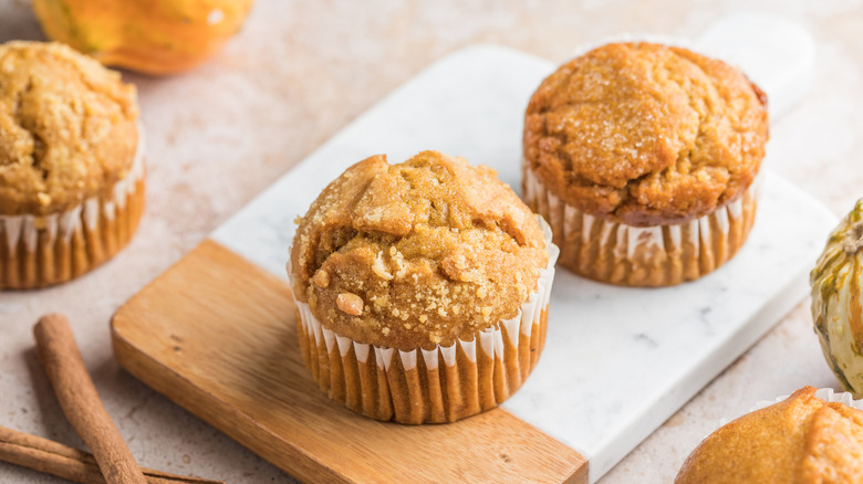 Pumpkin muffins on a wood and marble serving board