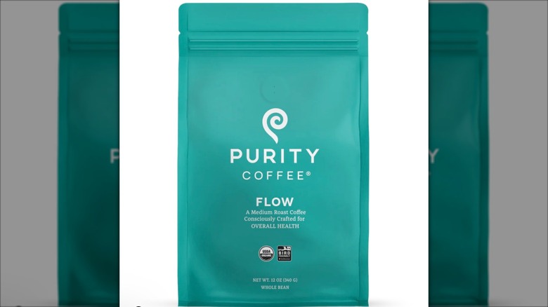 Blue bag of Purity Coffee Flow on white background