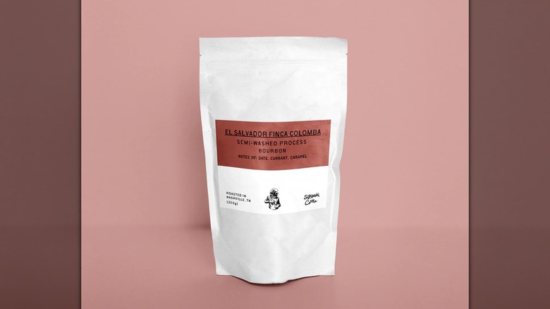 Bag of El Salvador Finca Colomba coffee from Subliminal Coffee Company on pink background