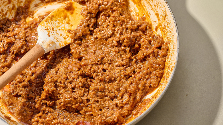 closeup of spatula in a pot of Coney sauce