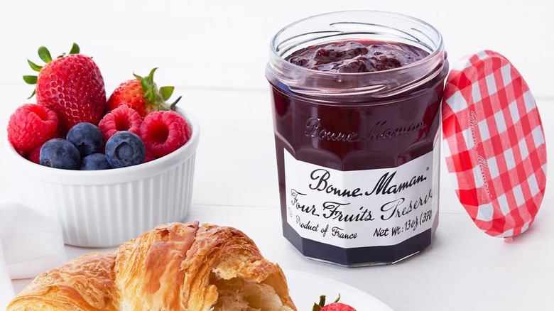 Jar of fruit preserves, berries, and croissant