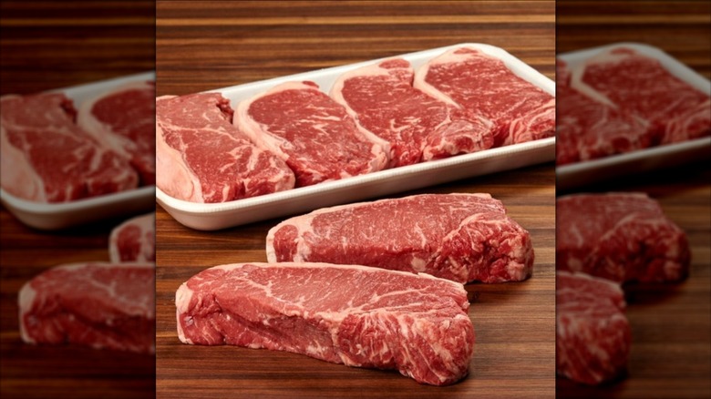 Kirkland Signature Prime Beef Loin New York Steaks on wooden surface