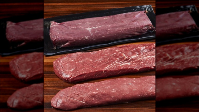 Three Premium Craft Beef Flat Iron Steaks from Costco sitting on wooden surface