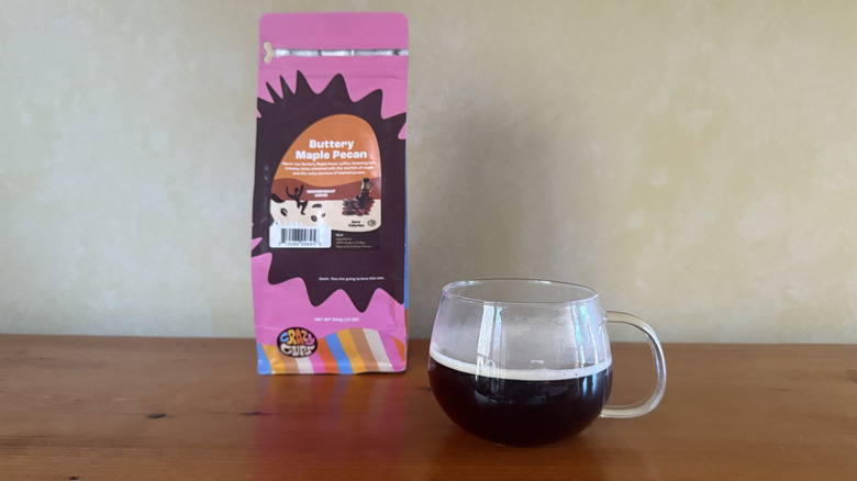 A bag of Buttery Mape Pecan Crazy Cups coffee with mug