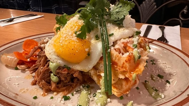 Fried egg on waffles and pulled pork