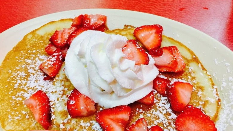 Pancakes with strawberries and whipped cream
