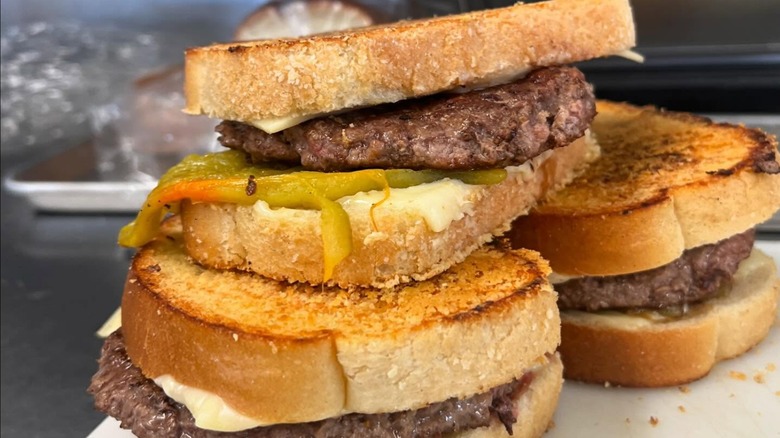 Stack of three Brian burgers at Emma Jean's Holland Burger Cafe