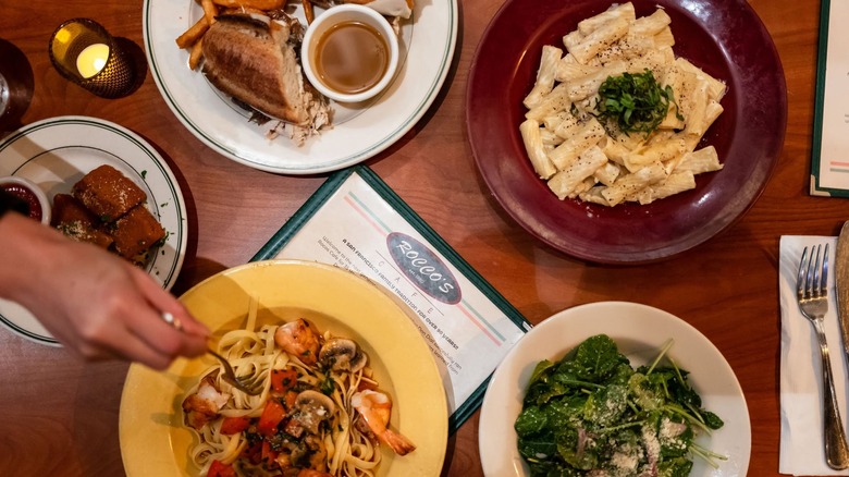Top view of pasta plates and salad at Rocco's Cafe