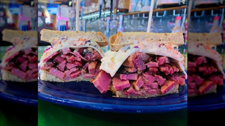 Pastrami sandwich with coleslaw and Swiss cheese at The Refuge
