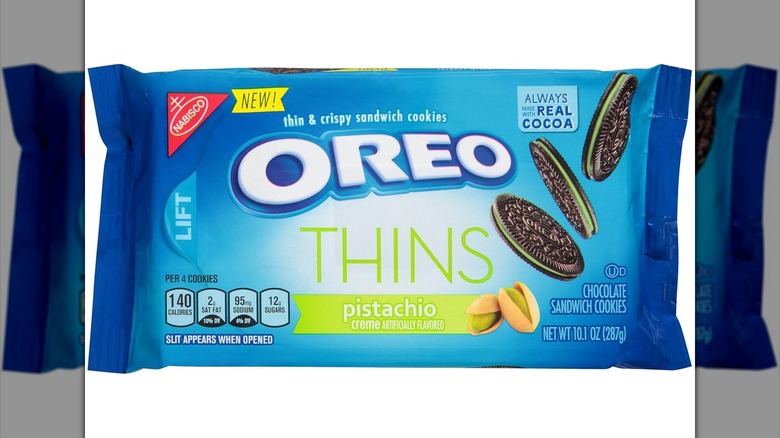 Blue package of Oreo Thins Pistachio flavor on white background