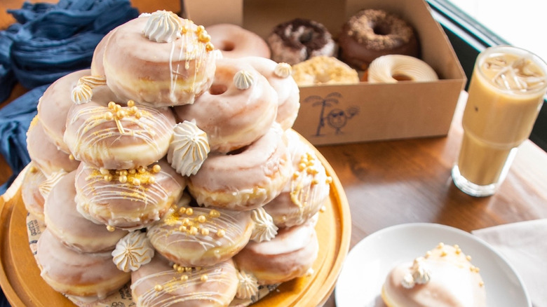 The Salty Donut donuts in stack with coffee and to go box